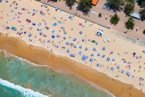 Beach goers enjoying the sunshine at Manly Beach 