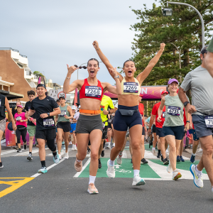2 runners smile at camera during Sun Run