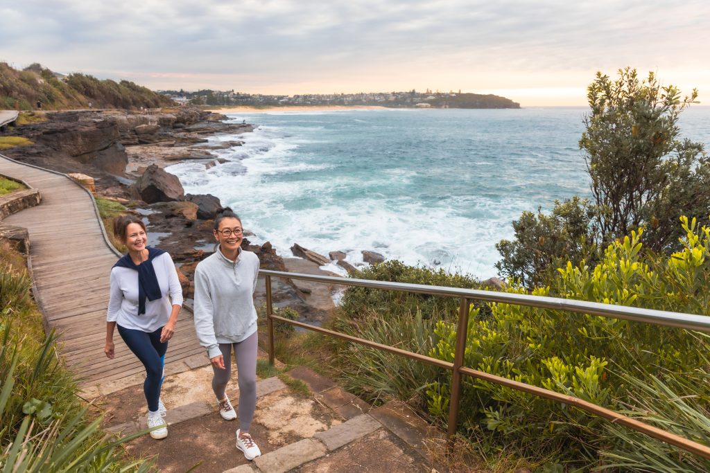 Two people walk on coastal walk